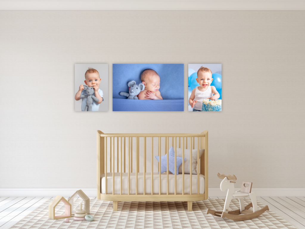 a series of 3 canvases hung above the babies cot, showcasing their growth throughout the first year. one is from the newborn session, while the other two are from the sitter and first birthday photo shoots