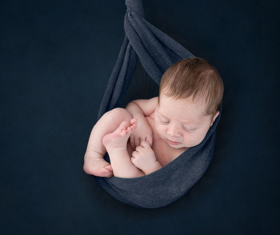 baby boy asleep in hammock - note this photo is done with baby safely on the floor, not hanging in mid air.